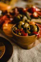 red and yellow fruit in brown wooden bowl
